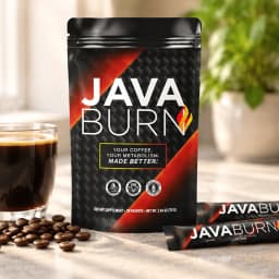 A Java Burn pouch and two stick sachets on a kitchen counter beside a cup of black coffee and scattered coffee beans